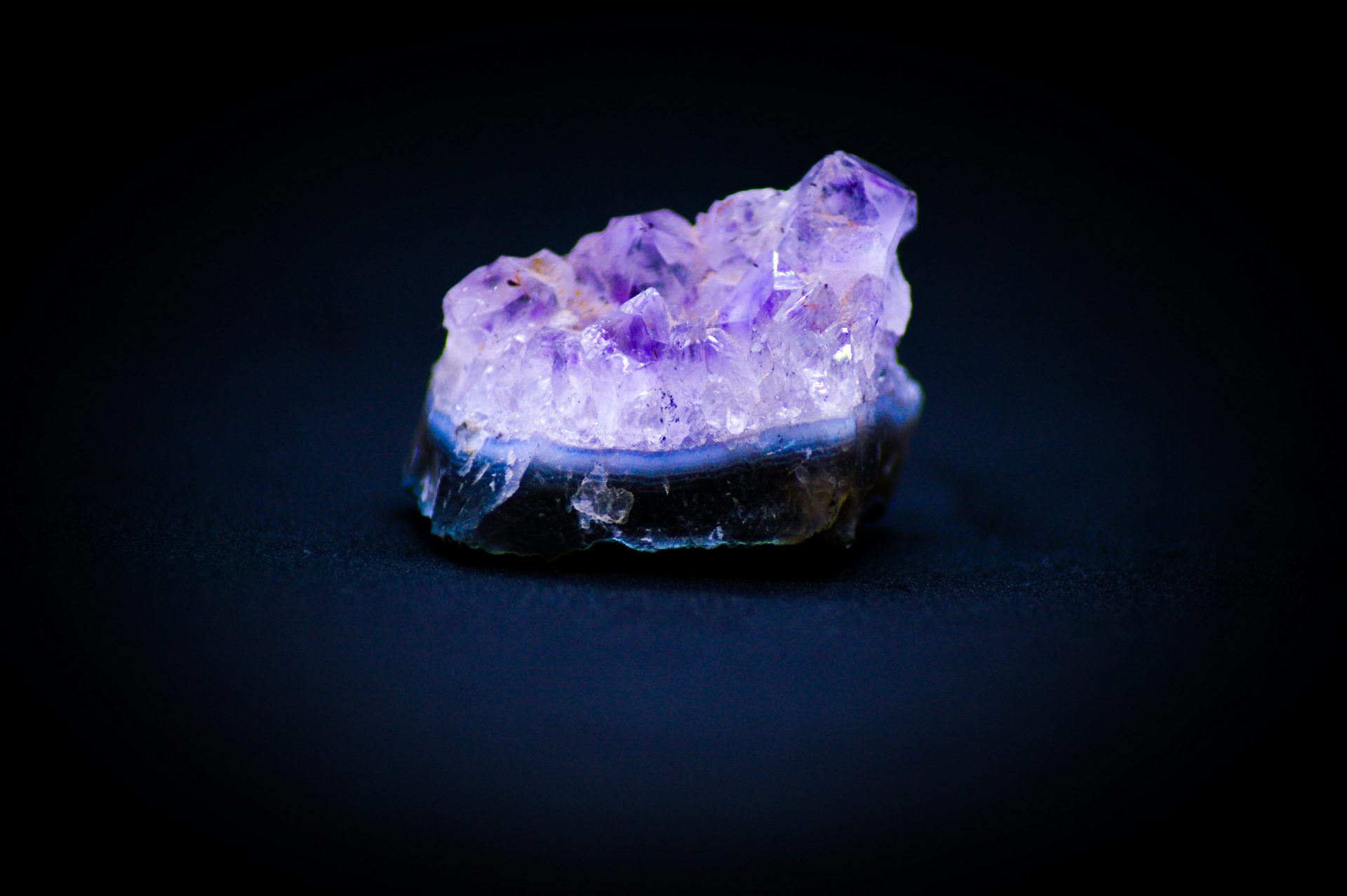 A cluster of purple crystals sitting on top of a table